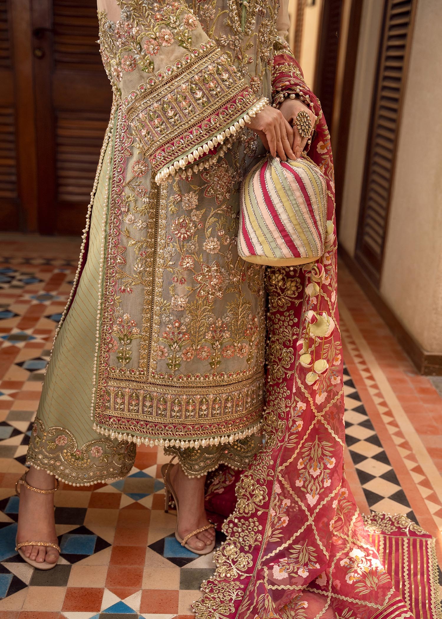 Artisanal Anecdotes Pakistani fashion outfit in gold, pink tones.